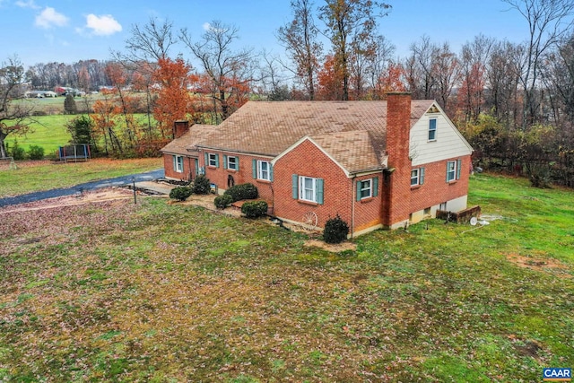 rear view of property with a yard