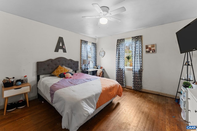 bedroom with ceiling fan and dark hardwood / wood-style flooring