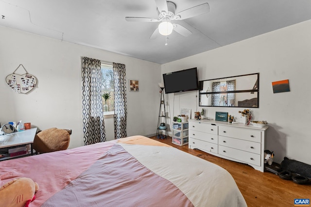 bedroom with ceiling fan and dark hardwood / wood-style floors