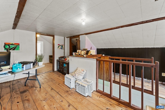 office with hardwood / wood-style floors and vaulted ceiling