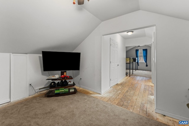 additional living space featuring light hardwood / wood-style floors, vaulted ceiling, and ceiling fan