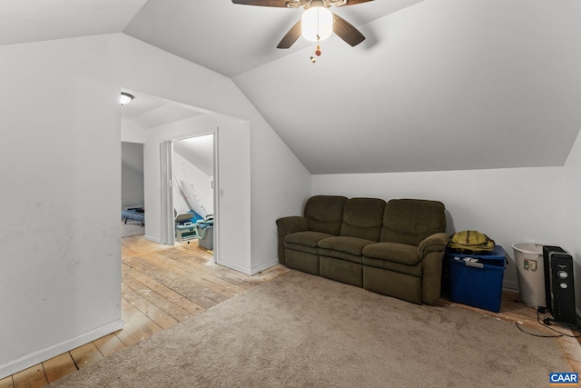 living room with ceiling fan, light hardwood / wood-style floors, and lofted ceiling