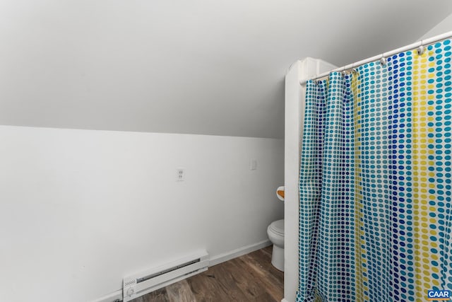 bathroom with a baseboard radiator, hardwood / wood-style flooring, toilet, curtained shower, and lofted ceiling