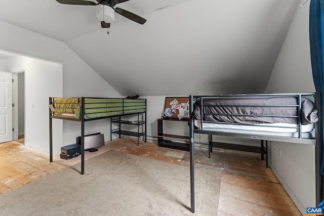 bedroom with ceiling fan, lofted ceiling, and carpet floors