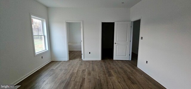 unfurnished bedroom featuring dark wood-type flooring