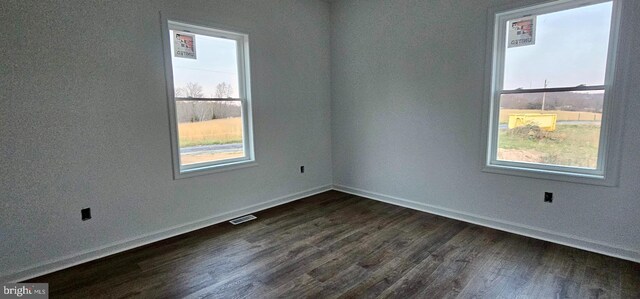 spare room with dark hardwood / wood-style flooring