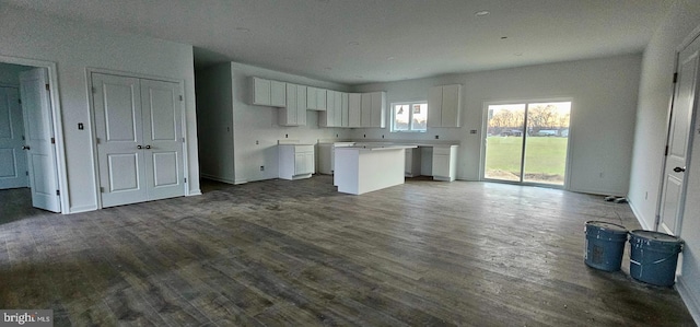 kitchen with a kitchen island, white cabinets, and dark hardwood / wood-style flooring