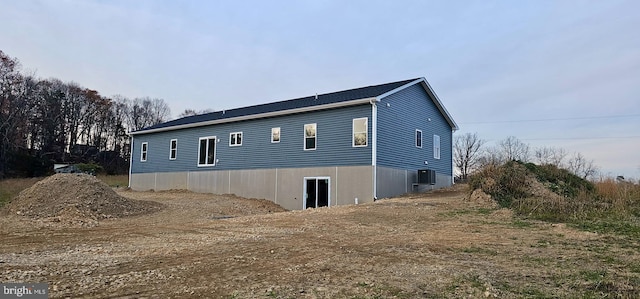 view of side of home with central air condition unit