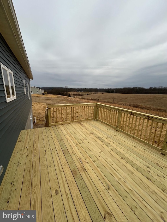 wooden deck featuring a rural view