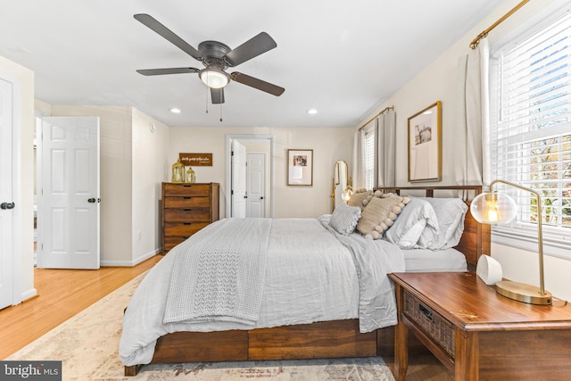 bedroom with ceiling fan and light hardwood / wood-style floors