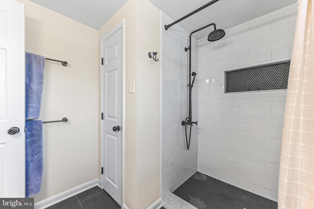 bathroom featuring a tile shower and tile patterned floors