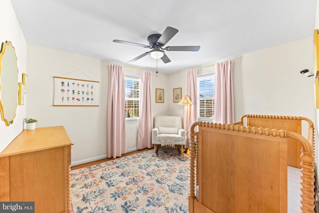 bedroom featuring multiple windows and ceiling fan