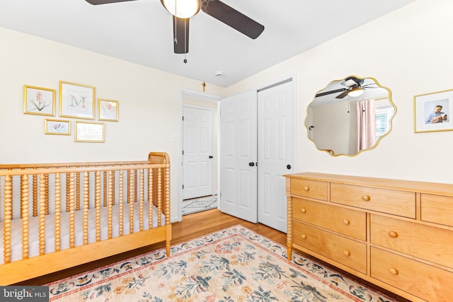 bedroom featuring light hardwood / wood-style flooring, a closet, and ceiling fan