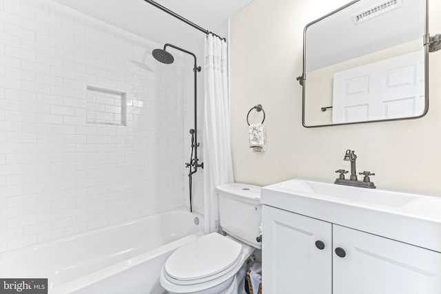 full bathroom featuring vanity, toilet, and tiled shower / bath combo