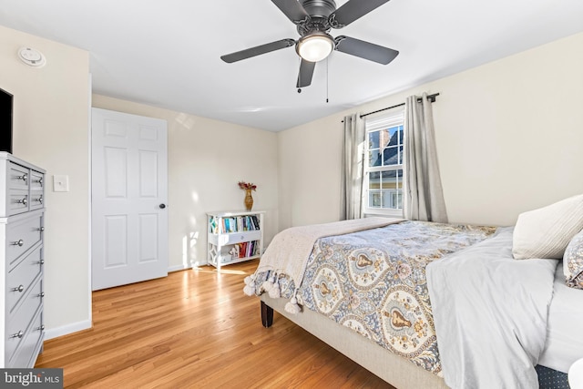 bedroom with ceiling fan and light hardwood / wood-style floors