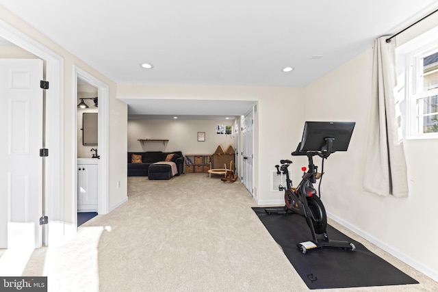 workout area featuring light colored carpet