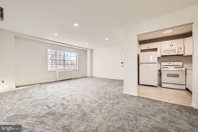 kitchen featuring white cabinets, light carpet, white appliances, and radiator