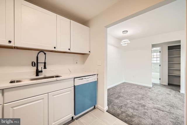 kitchen featuring dishwasher, white cabinets, light colored carpet, and sink