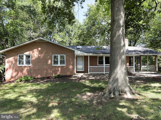 single story home with a porch and a front yard