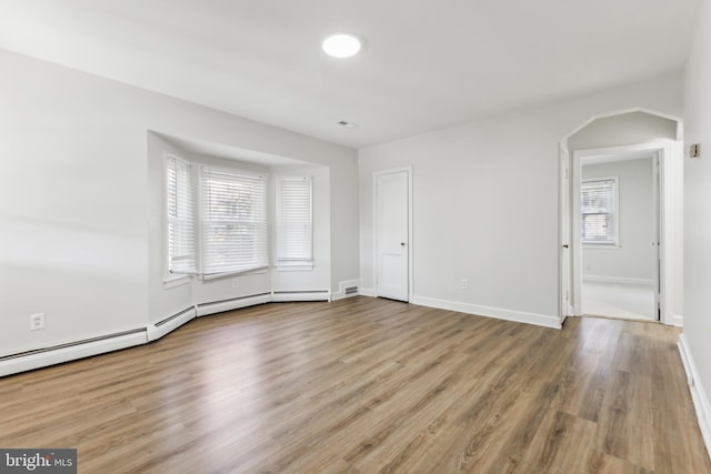 spare room featuring plenty of natural light and light hardwood / wood-style floors