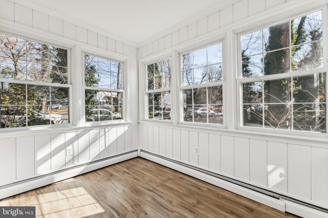 unfurnished sunroom featuring baseboard heating