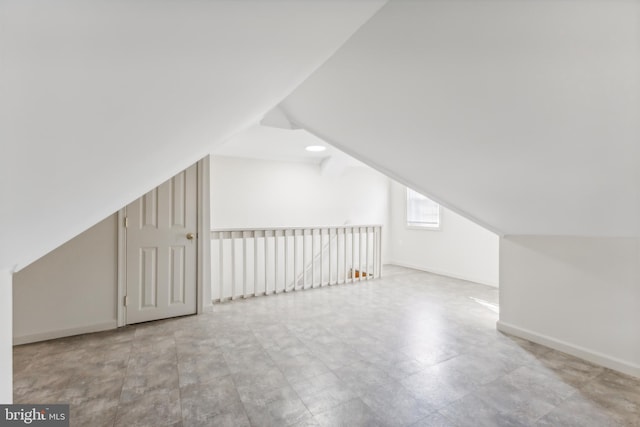 additional living space featuring lofted ceiling