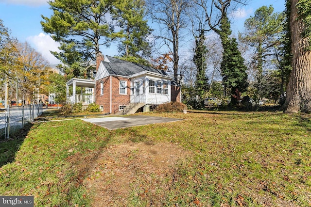 rear view of property featuring a yard