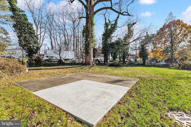 view of yard with basketball hoop