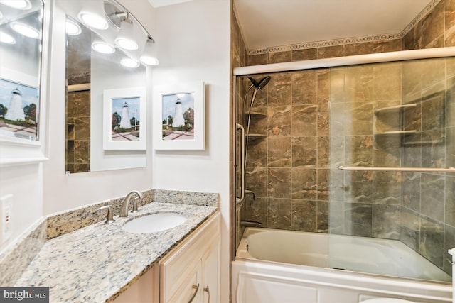 bathroom featuring vanity and bath / shower combo with glass door