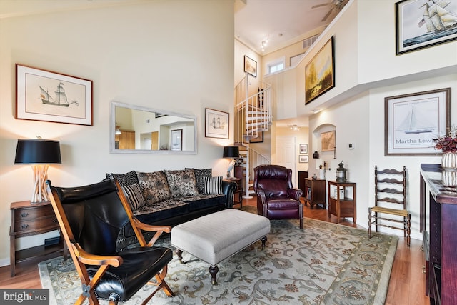 living room with high vaulted ceiling and light hardwood / wood-style floors