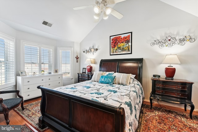 bedroom featuring multiple windows, ceiling fan, dark hardwood / wood-style floors, and lofted ceiling