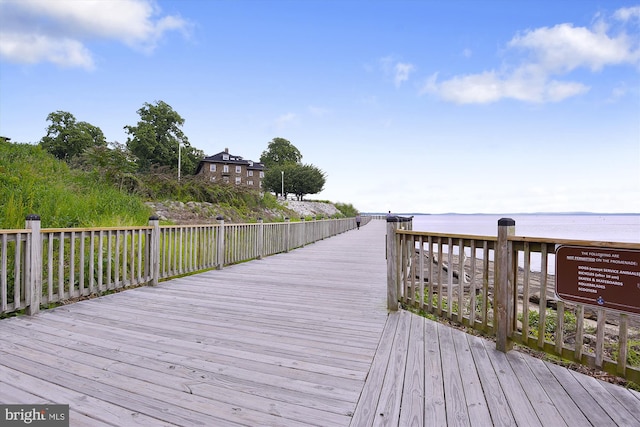 exterior space featuring a deck with water view