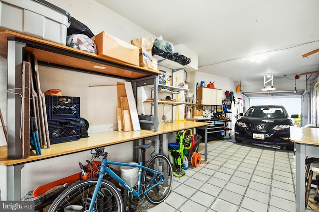 garage with a workshop area and a garage door opener