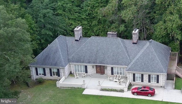 rear view of house featuring an outdoor living space, a yard, and a patio