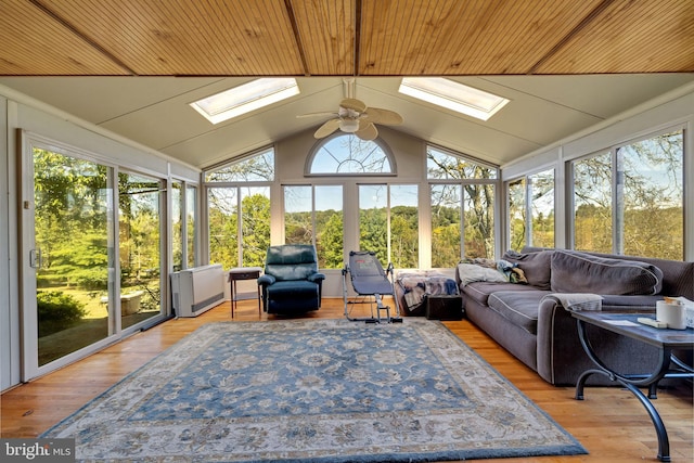 sunroom / solarium with ceiling fan and lofted ceiling with skylight