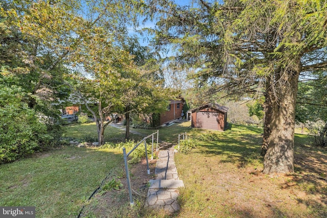 view of yard featuring a garage and an outdoor structure