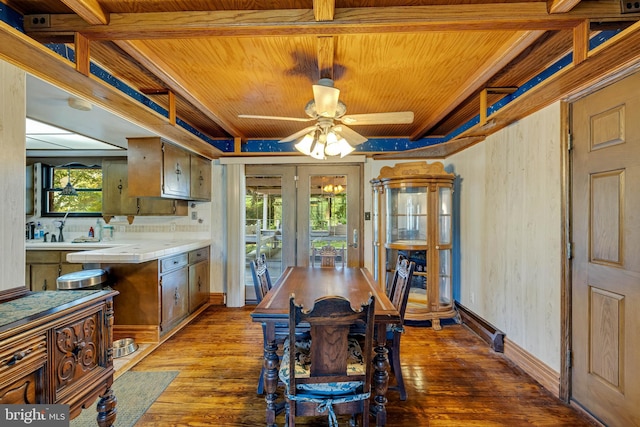 dining area with dark wood-type flooring, a baseboard radiator, ceiling fan, and a healthy amount of sunlight