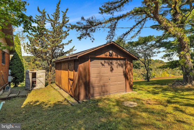 view of outbuilding with a yard