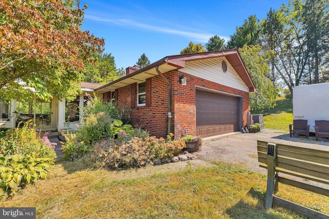 view of side of home with a garage and a yard