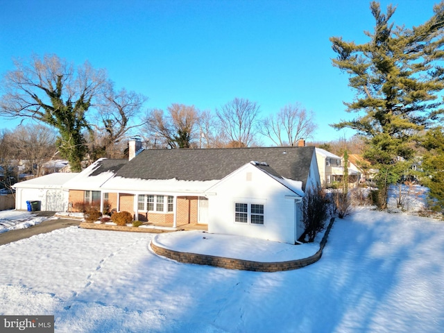 view of snow covered rear of property