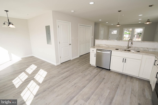 kitchen featuring dishwasher, white cabinets, hanging light fixtures, and sink