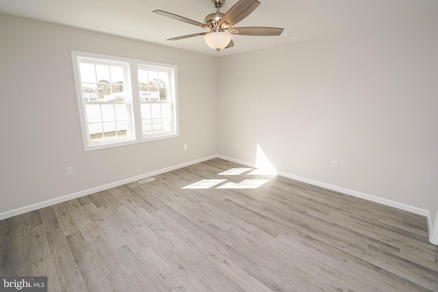 unfurnished room with hardwood / wood-style floors and ceiling fan