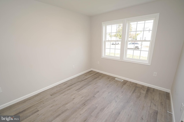 spare room with light wood-type flooring