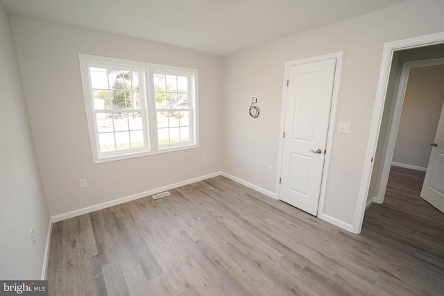 spare room with light wood-type flooring