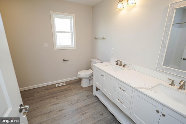 bathroom featuring hardwood / wood-style floors, vanity, and toilet