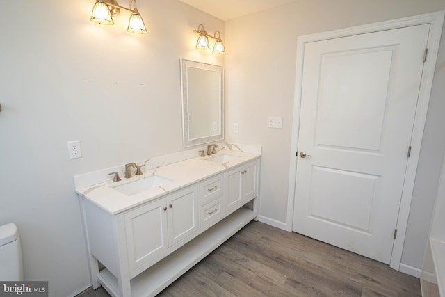 bathroom featuring hardwood / wood-style flooring, vanity, and toilet