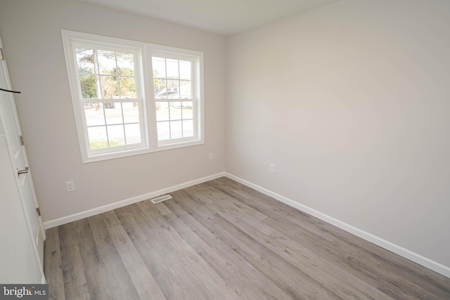 spare room with light wood-type flooring