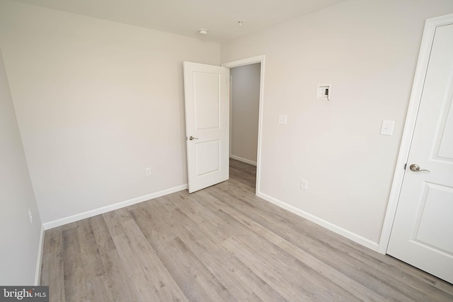 spare room featuring light hardwood / wood-style flooring