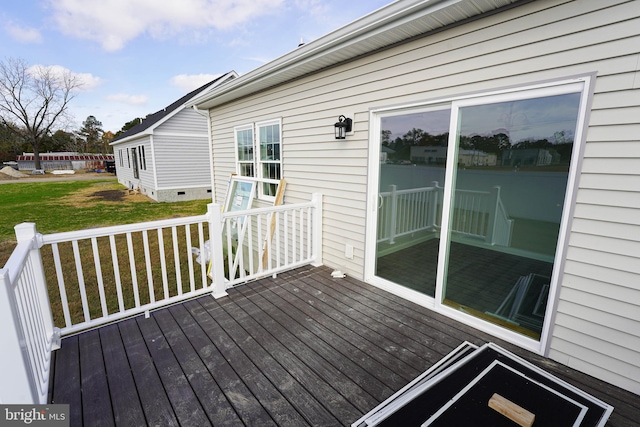 wooden deck featuring a yard