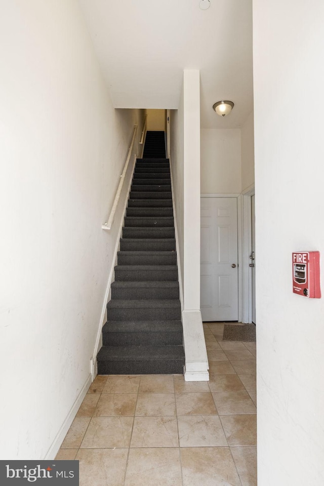 stairs with tile patterned flooring